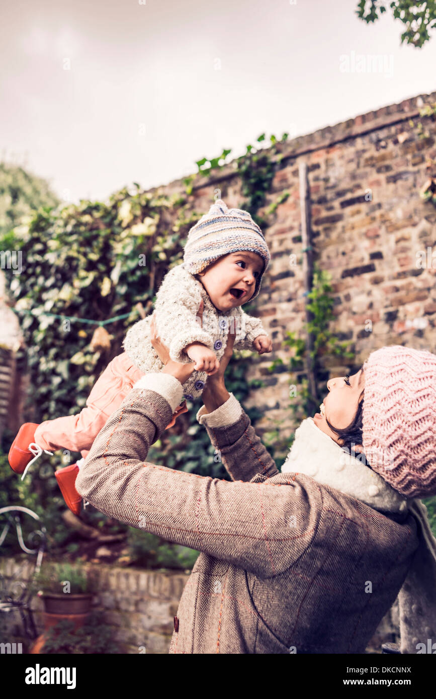 Mother throwing baby in air Stock Photo Alamy