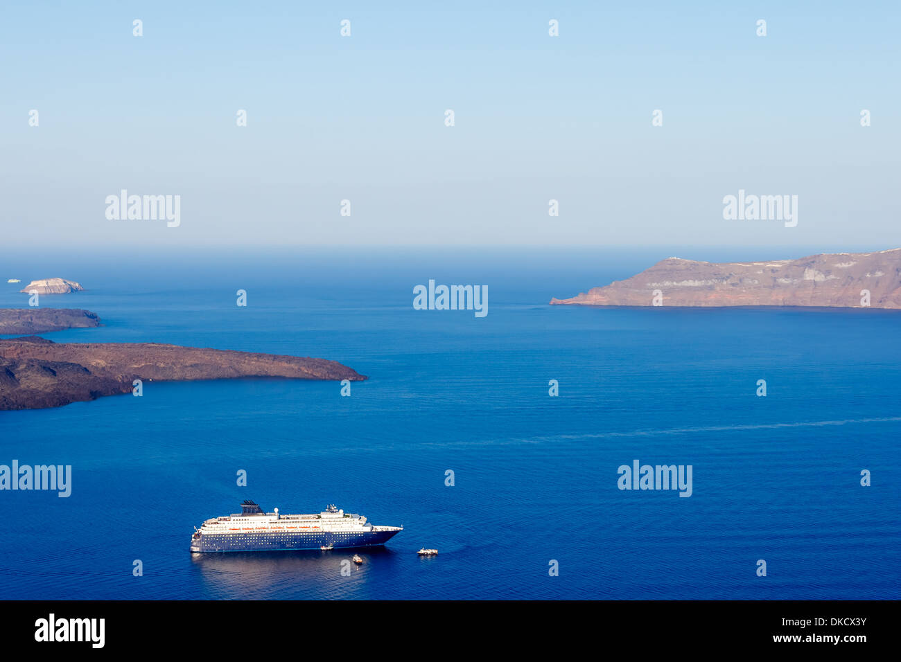 Nea Kameni volcanic island in Santorini Greece with ships in front photographed from a high point of view Stock Photo