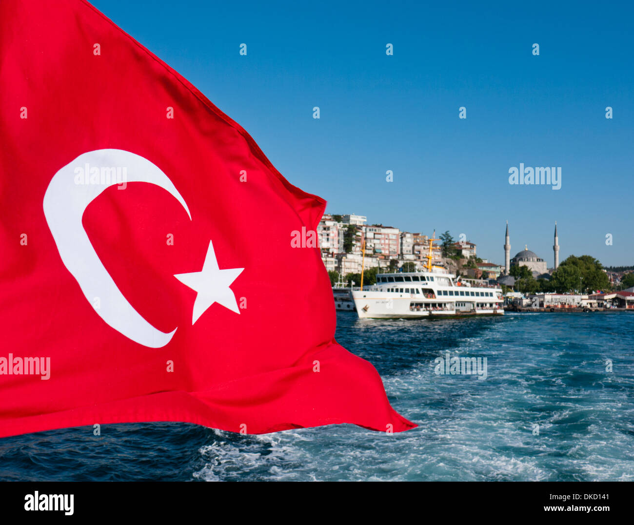 A Turkish flag on the back of a boat crossing the Bosphorus in Istanbul Turkey Stock Photo