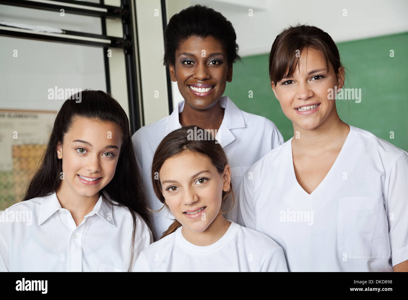 Teacher And Female Students In Science Lab Stock Photo