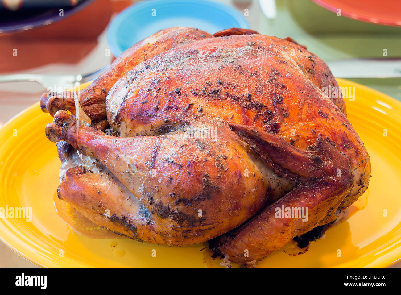 Cooked Roast Turkey on Yellow Platter for Thanksgiving Dinner Stock Photo