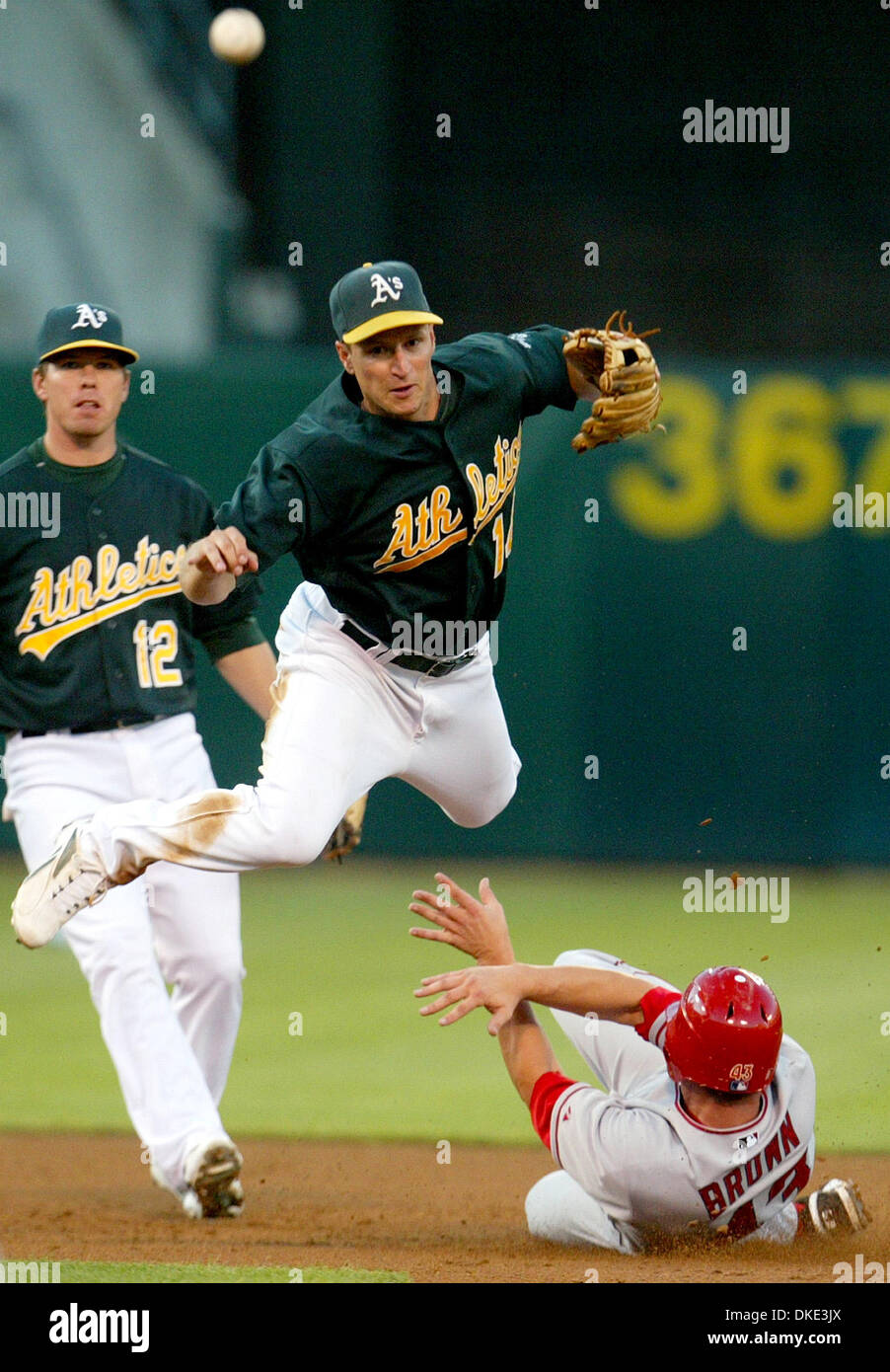 August 3rd 2007 - Oakland, CA, USA -  Oakland Athletics Mark Ellis leaps over Los Angeles Angels Matt Brown while throwing to first to double up Ryan Budde in the third inning at McAfee Coliseum in Oakland on Friday August 3, 2007.  (Credit Image: © Sean Connelley/The Oakland Tribune/ZUMA Press) Stock Photo