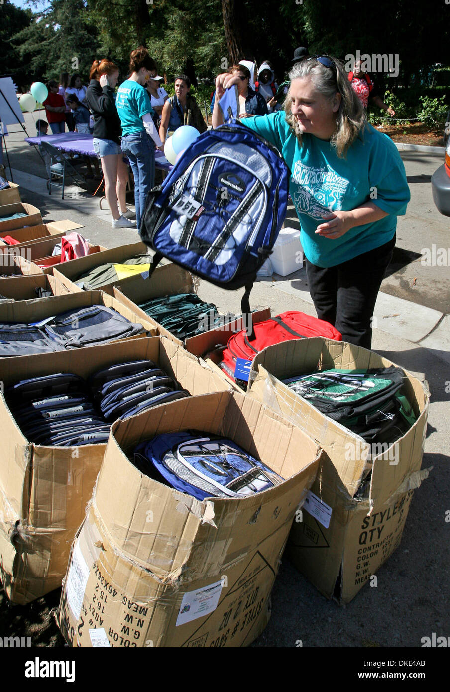 Lynn Stanaway selects  a backpack at Backpackalooza at Central Park, in San Mateo , Saturday, August 11, 2007. The annual event sponsored by Burlingame United Methodist Church gives away backpacks  to children who cannot afford them. (John Green/San Mateo County Times) Stock Photo