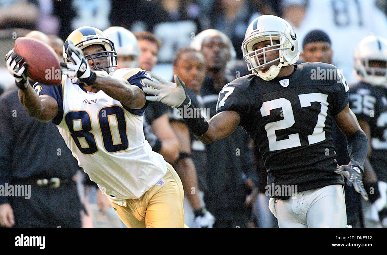 Rams wide reciever Isaac Bruce pulls in a pass in front of Raiders