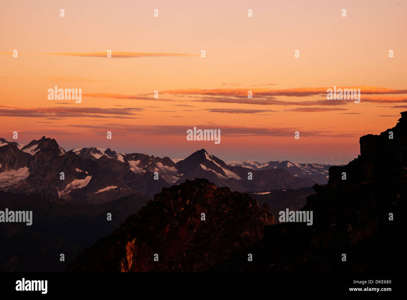 A brilliant sunrise over mountain peaks in the Canadian Bugaboo range. Stock Photo