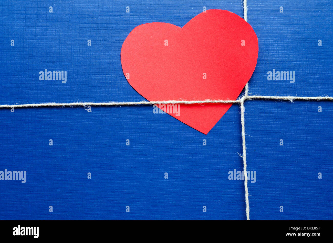 Blue paper package or gift with red heart shape valentine card. Stock Photo
