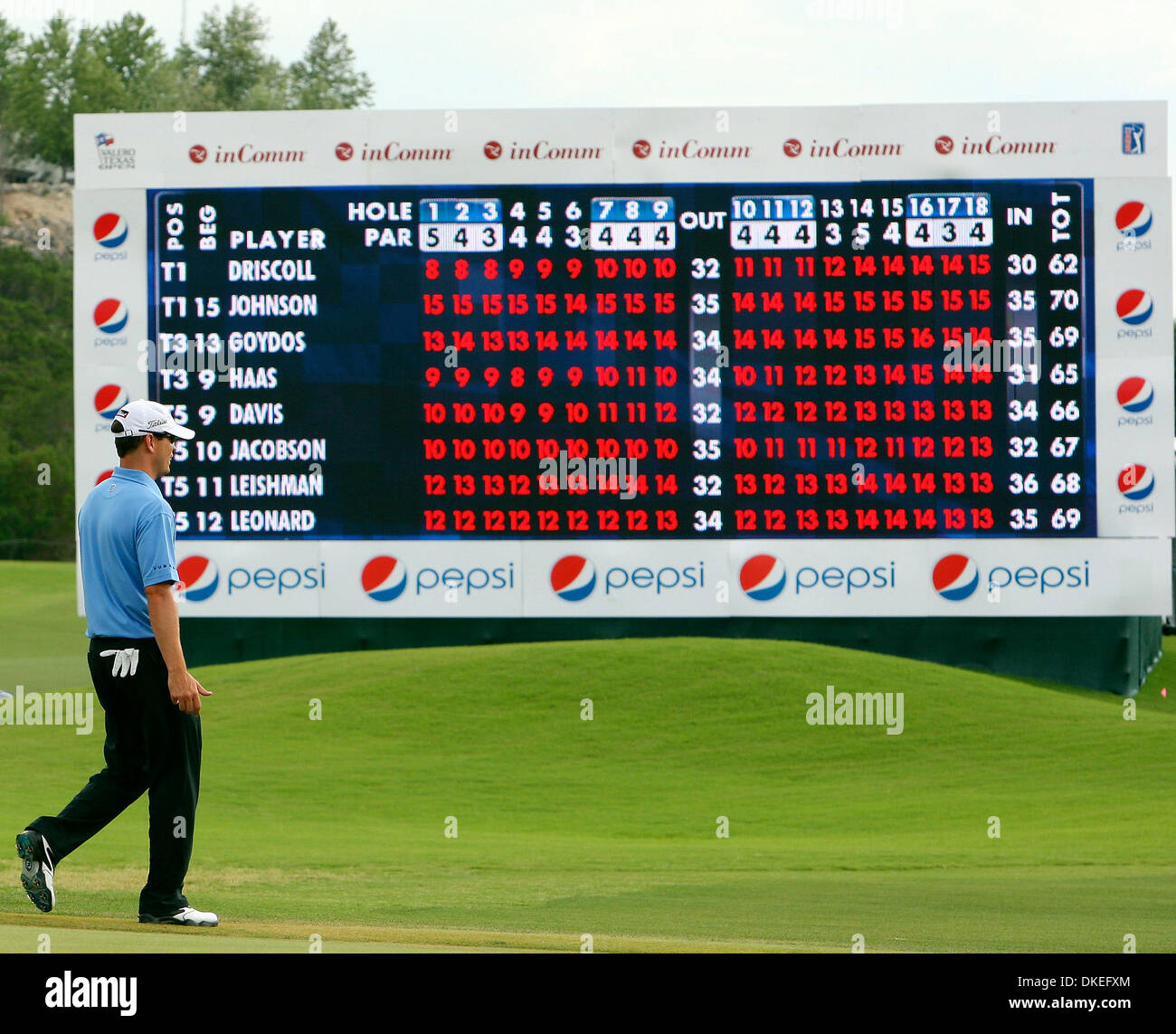 FOR METRO Zach Johnson walks past the leader board during the Valero