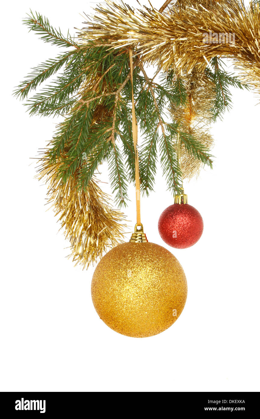 Baubles and tinsel hanging from a branch of a Christmas tree Stock ...