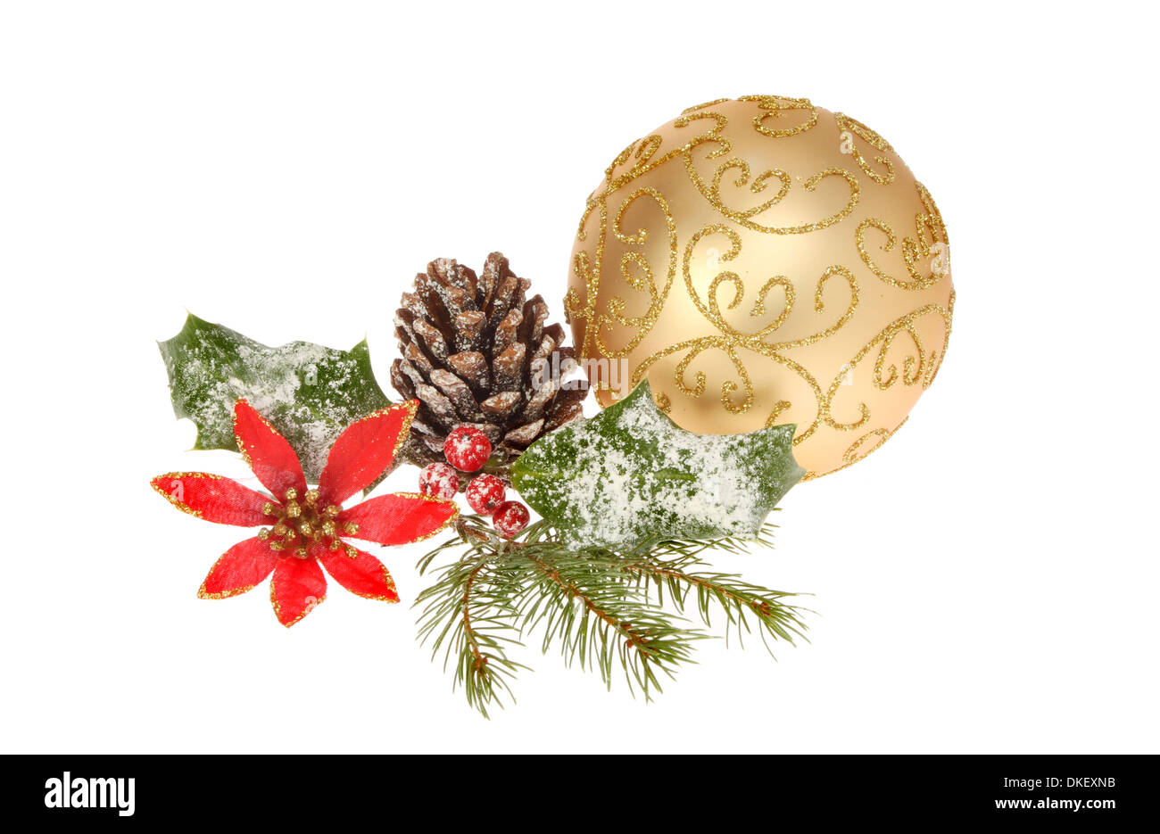 Christmas decoration of seasonal foliage and a gold bauble isolated against white Stock Photo