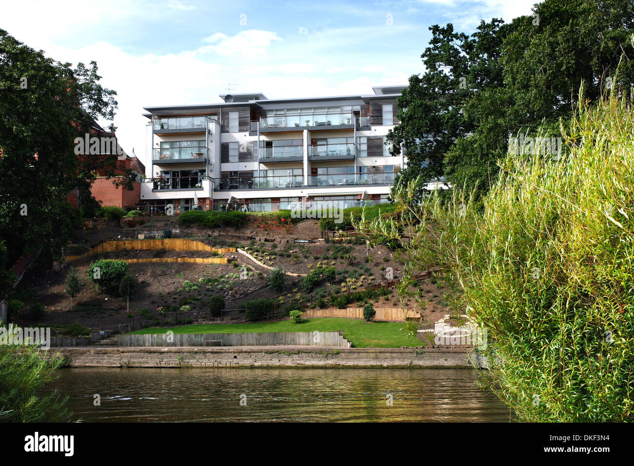 The River Dee at Chester, England, showing modern riverside apartments with terraced waterfront gardens. Stock Photo
