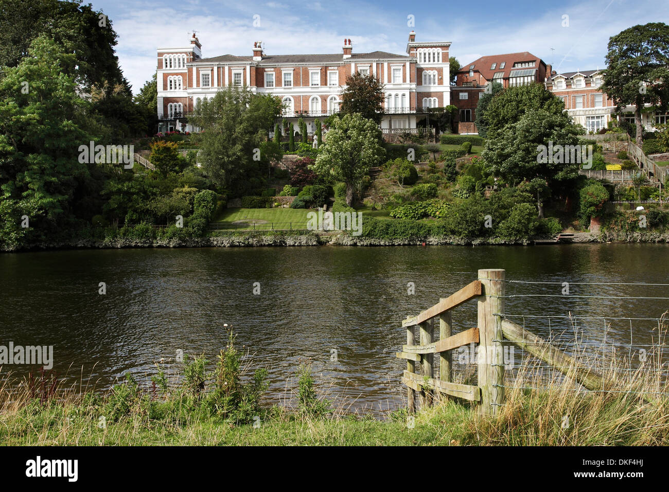 The River Dee at Chester, England, showing large riverside properties with waterfront gardens. Stock Photo