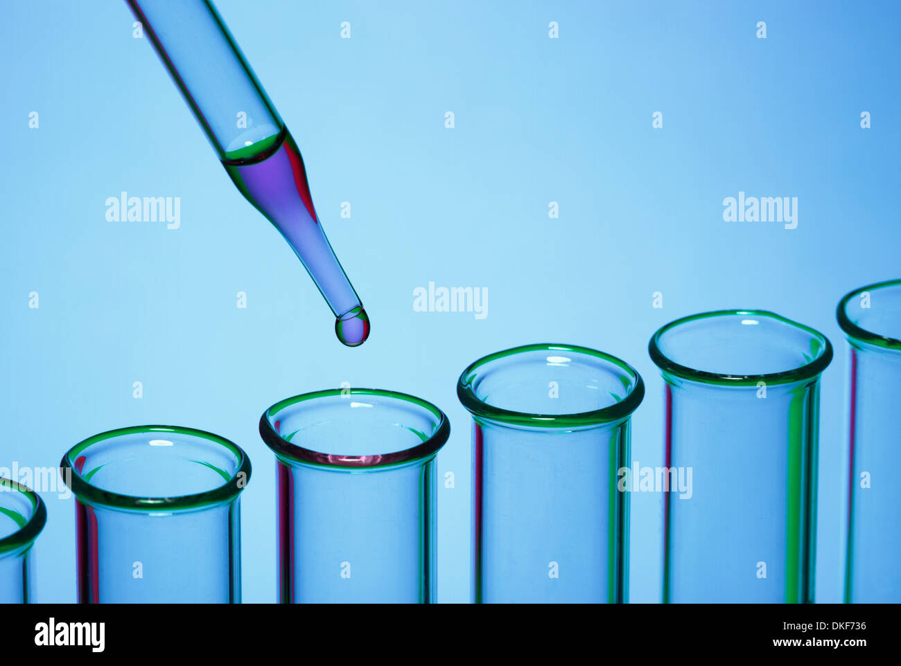 Pipetting: a dropper pipette is used to transfer a small amount of liquid to a test tube Stock Photo