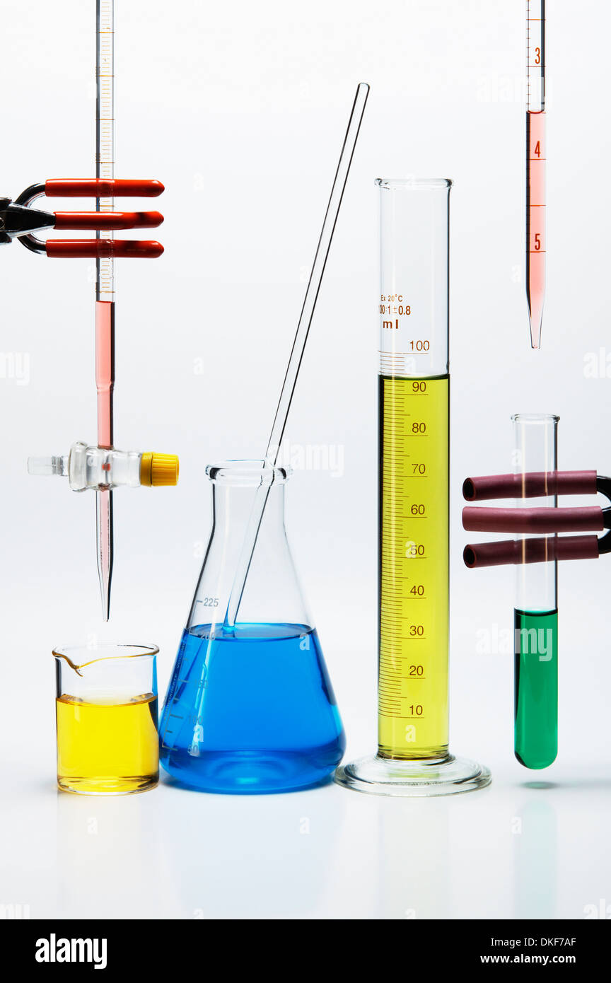 Chemical lab glassware: burette over beaker, Erlenmeyer flask with stirring rod, graduated cylinder, pipette over test tube Stock Photo