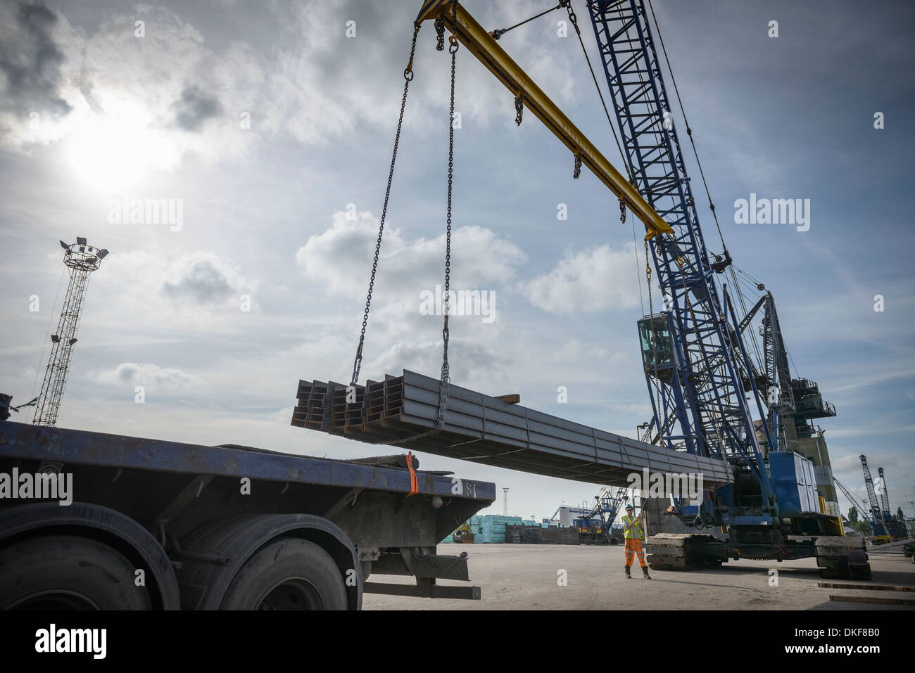 Crane unloading steel from ship in port Stock Photo