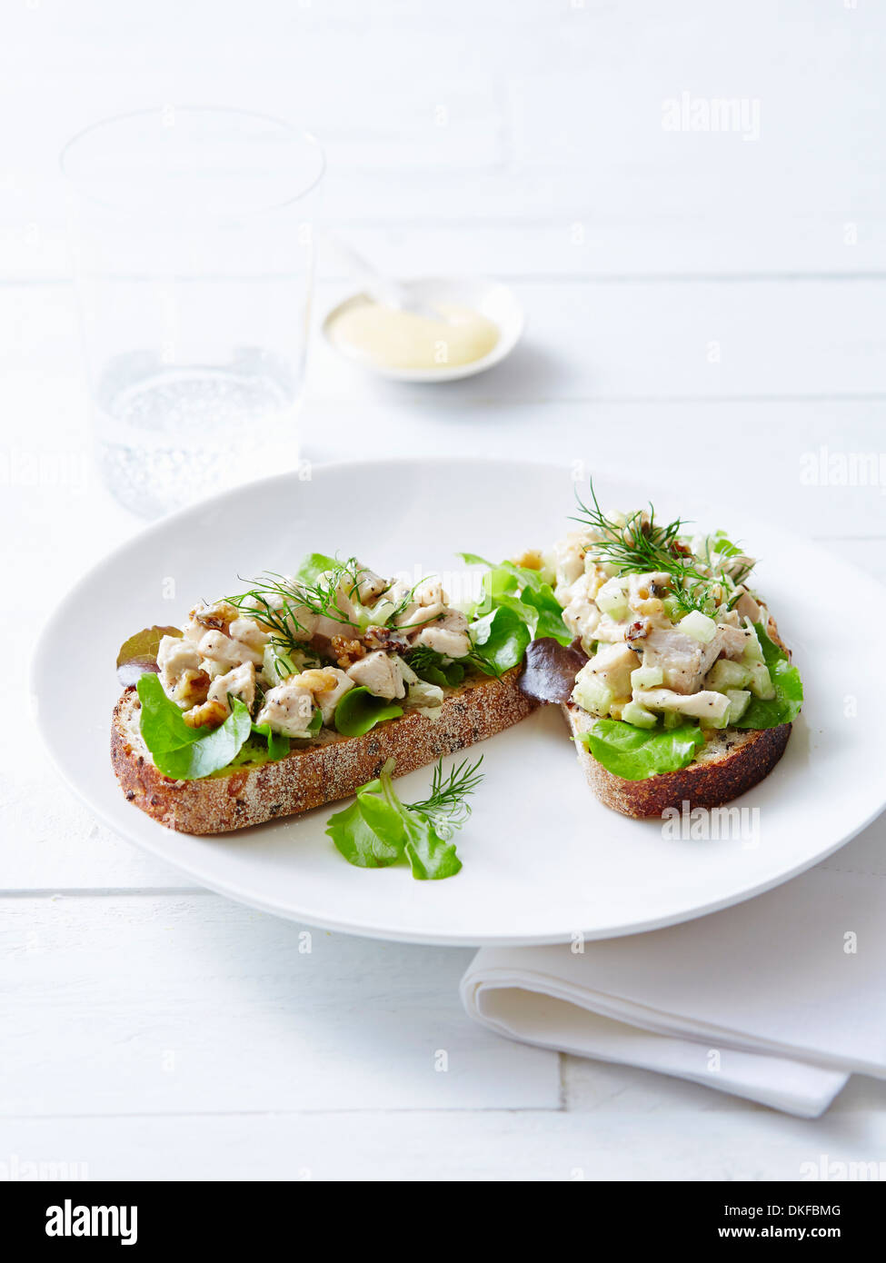 Still life of open chicken sandwiches and herbs Stock Photo