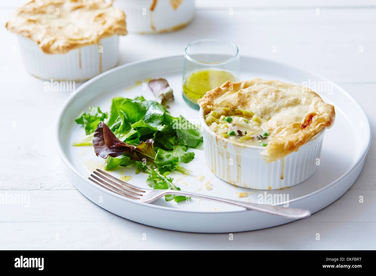 Still life of chicken, leek and pea pies Stock Photo