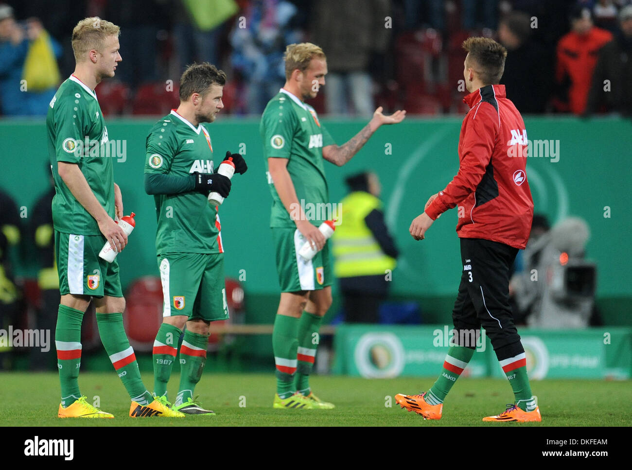 Augsburg, Germany. 04th Dec, 2013. Augsburg's Andre Hahn (L-R), Daniel Baier and Raphael Holzhauser are disappointed after the DFB cup round of sixteen match between FC Augsburg and FC Bayern Munich at the SGL Arena in Augsburg, Germany, 04 December 2013. Photo: Andreas Gebert/dpa/Alamy Live News Stock Photo
