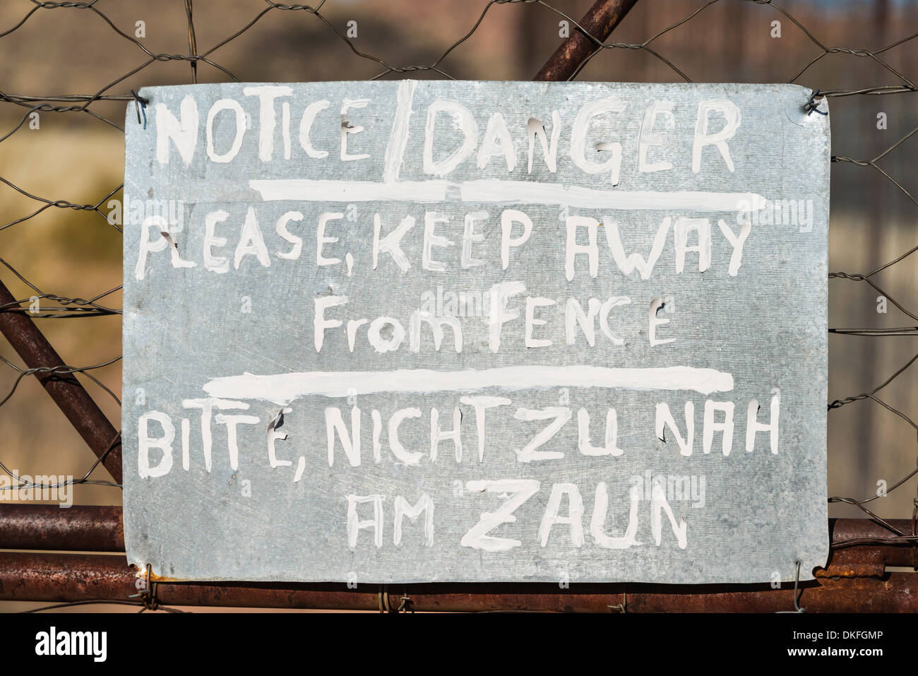 Warning sign in English and German on the fence of a predator enclosure ...