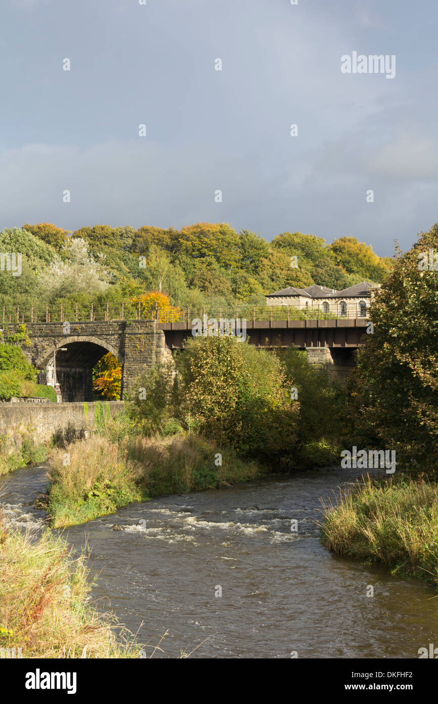 The river Irwell and railway bridge carrying the East Lancs Railway in Lancashire village of Summerseat, near Bury, Lancashire. Stock Photo