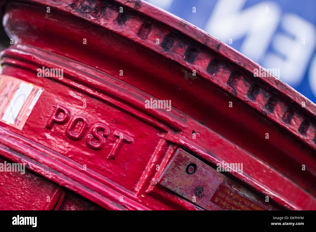 Close up detail image of a UK Royal Mail Red Pillar Box with the word POST clearly shown. Stock Photo