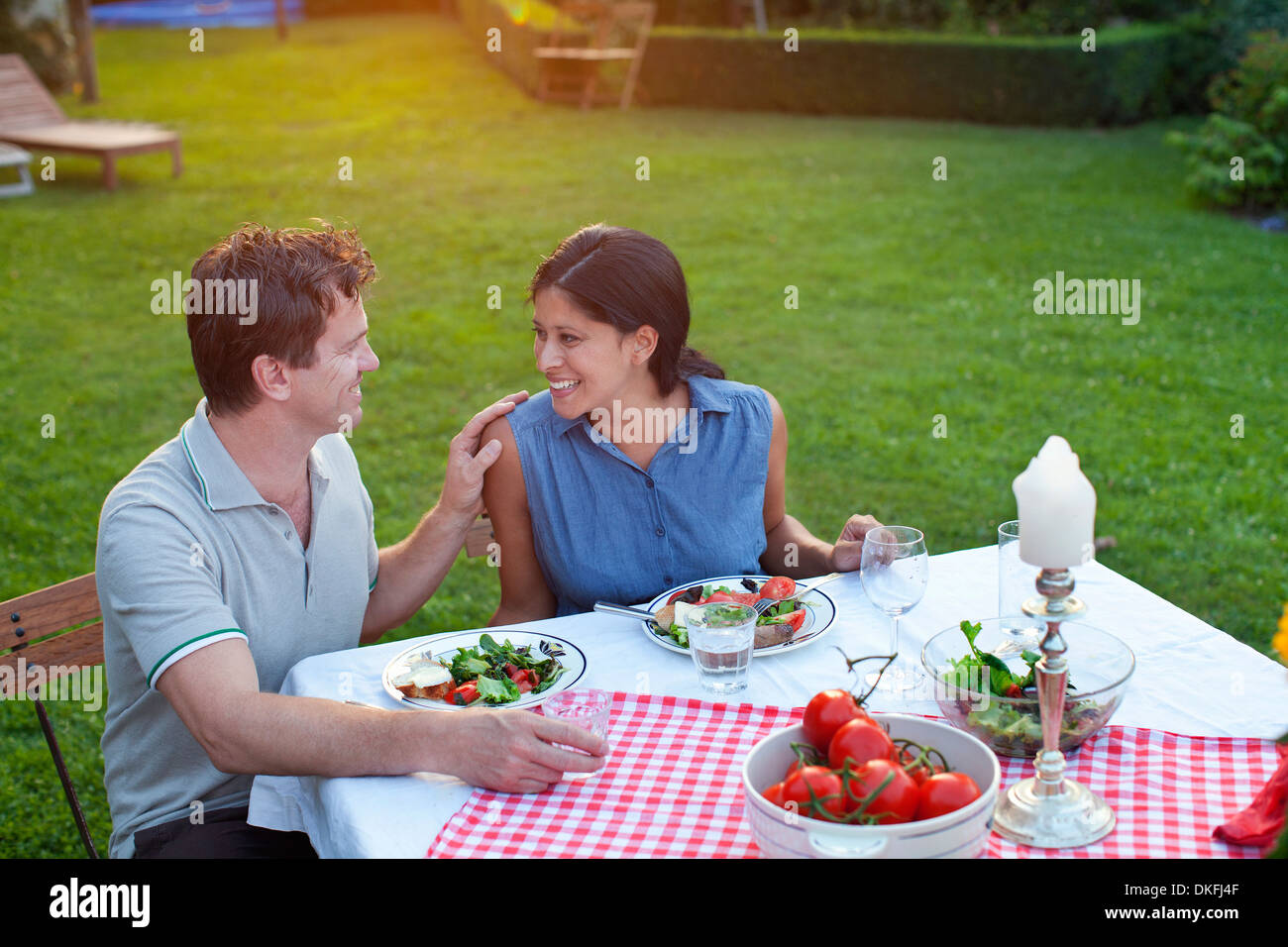 Couple having dinner in garden Stock Photo