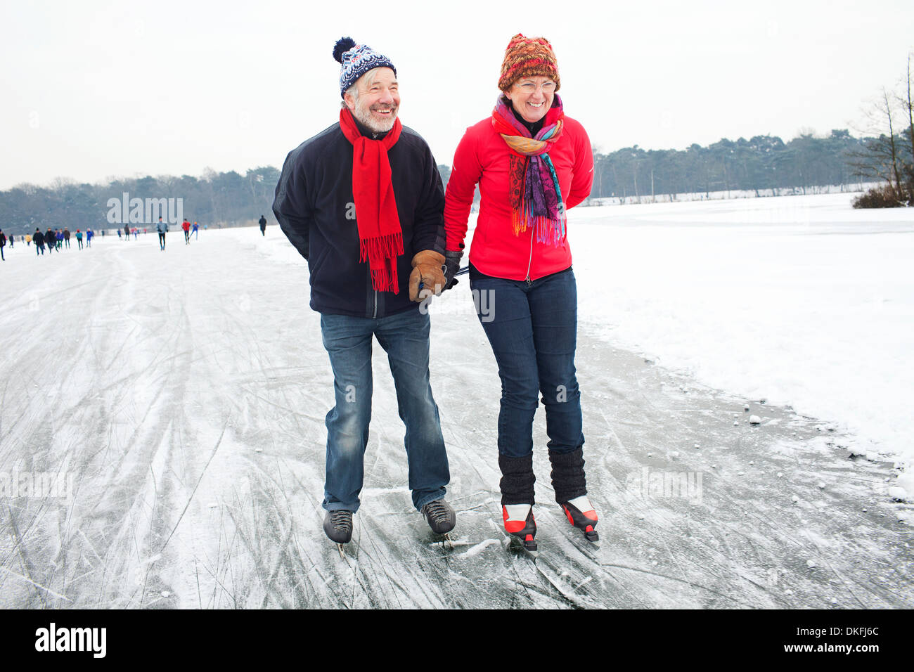 Couple ice skating, holding hands Stock Photo Alamy