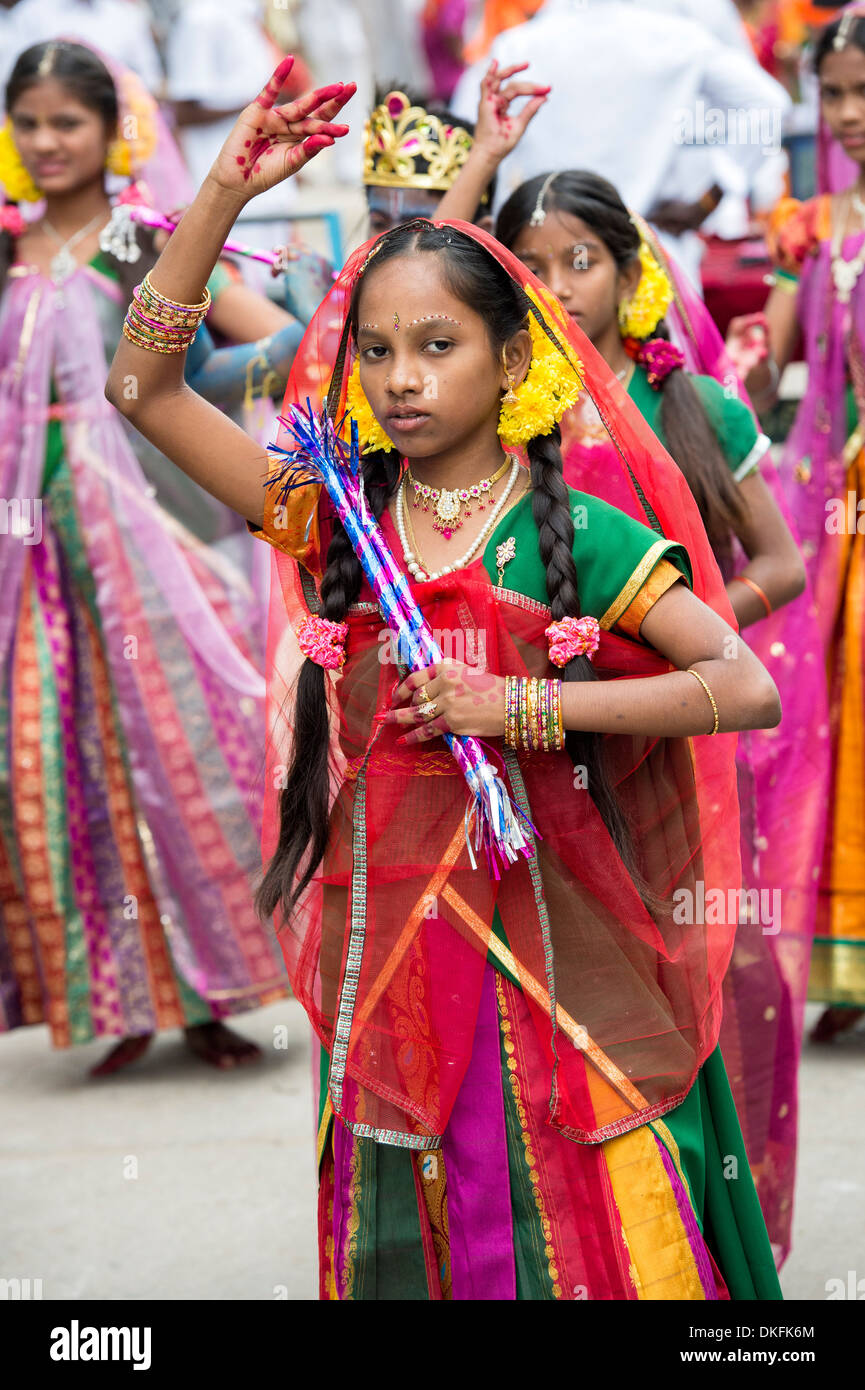 Indian girls in traditional dress dancing at a festival in the streets of Puttaparthi. Andhra Pradesh, India Stock Photo