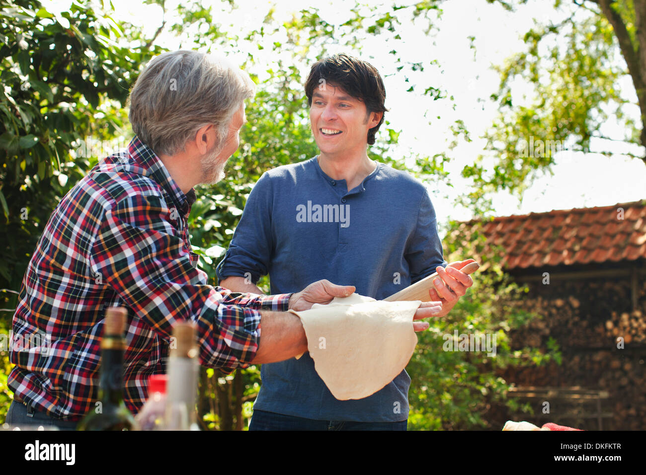 Father and adult son making pizza dough Stock Photo Alamy