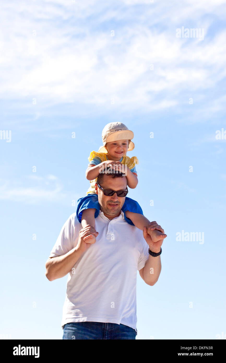 Father carrying daughter on shoulders Stock Photo