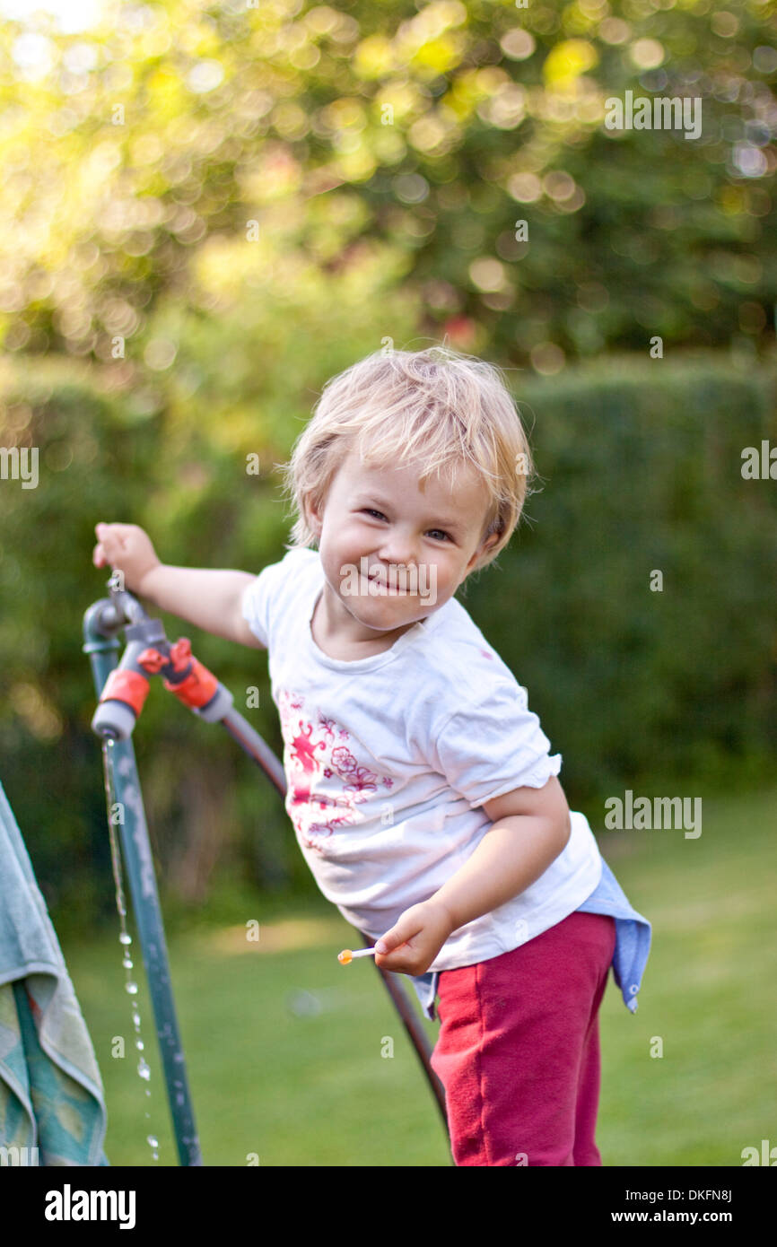 Happy blond girl in garden Stock Photo