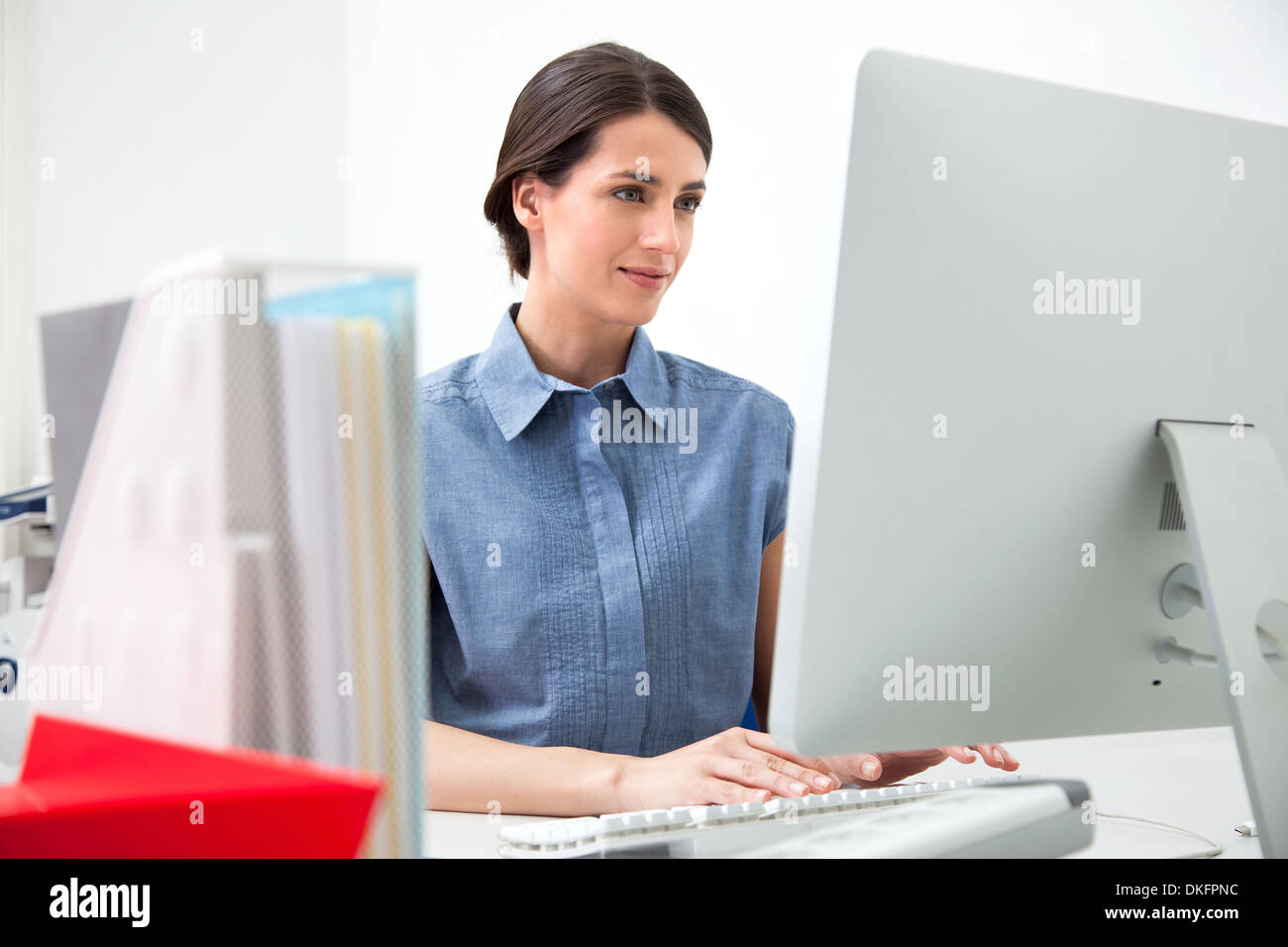 Young woman working on computer Stock Photo