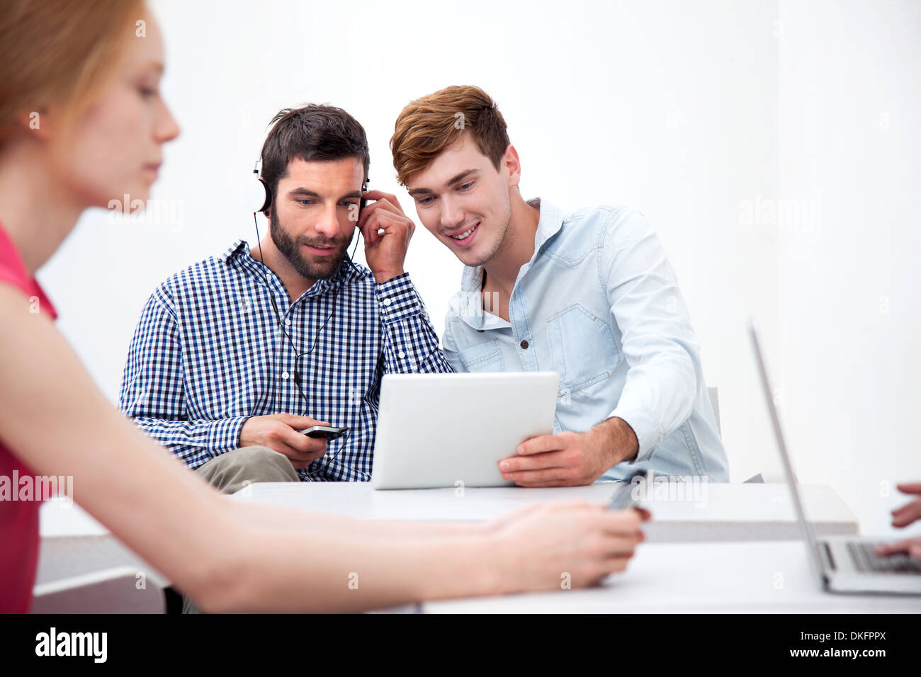 Two male colleagues using digital tablet Stock Photo