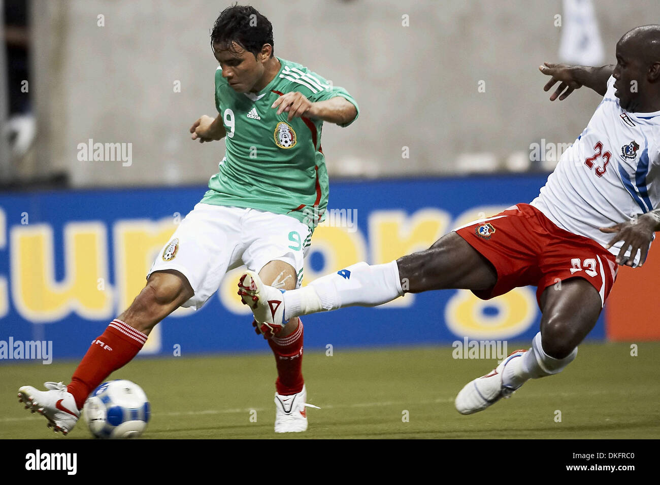 Jul 10, 2009 - Houston, Texas, USA - OMAR BRAVO (#9) of Mexico attempts to retain control of the ball as FELIPE BALOY (#23) of Panama dives in on a tackle.  Panama and Mexico tied 1-1 at Reliant Stadium. (Credit Image: © Diana Porter/Southcreek Global/ZUMA Press) Stock Photo