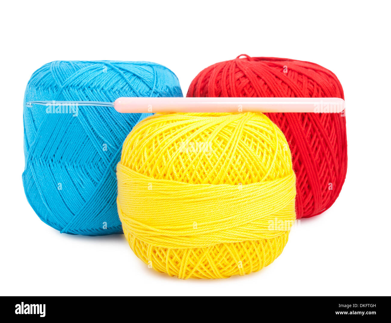 blue, yellow and red ball of yarn with hook for knitting Stock Photo