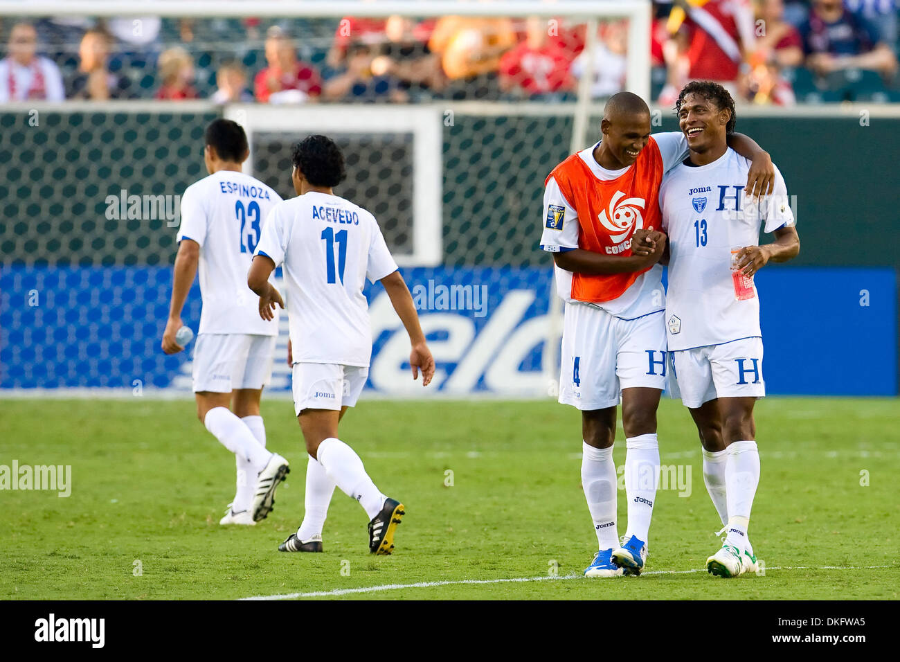 Jul 18, 2009 - Philadelphia, Pennsylvania, USA - Honduras' defender CARLOS PALACIOS (14) celebrating with Canada's defender ATIBA HUTCHINSON (13) as teammates  midfielder ROGER ESQINOZA (23) and defender MARIANO ACEVEDO (11) head to the rest of their teammates during the CONCACAF Gold Cup quarter finals match between Canada and Honduras at Lincoln Financial Field in Philadelphia, P Stock Photo