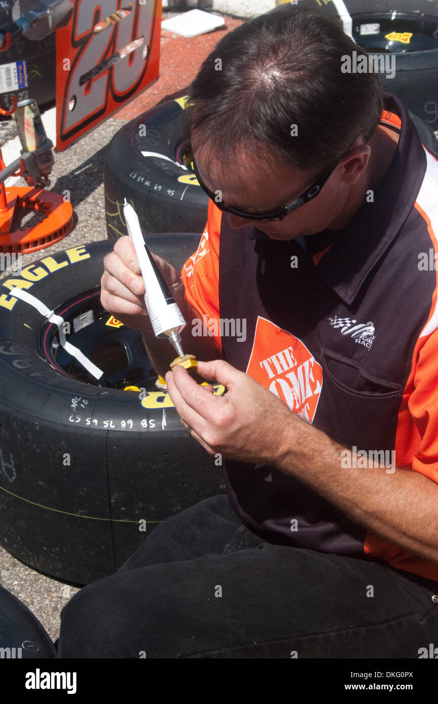 June 14, 2009 - Brooklyn, Michigan, U.S - 14 June 2009:  A Home Depot crew member works on putting the lugnuts onto the race tires before the race. NASCAR Lifelock 400 was held at Michigan International Speedway in Brooklyn, Michigan (Credit Image: © Alan Ashley/Southcreek Global/ZUMApress.com) Stock Photo