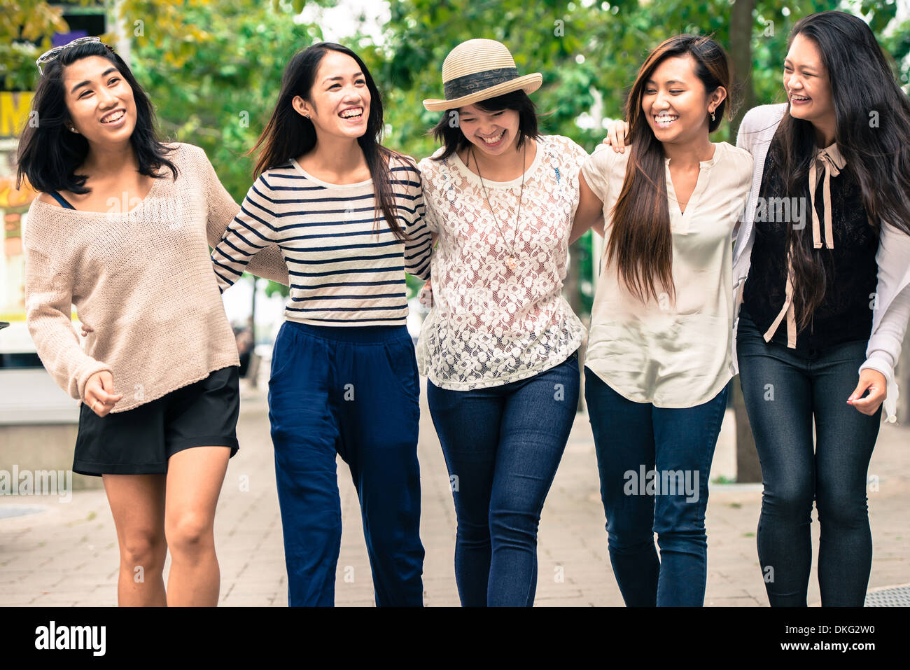 Group of five young women with arms around, smiling Stock Photo - Alamy