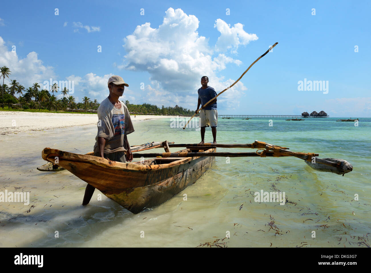 Fishermen and traditional outrigger boat, Bwejuu Beach, Zanzibar, Tanzania, East Africa, Africa Stock Photo