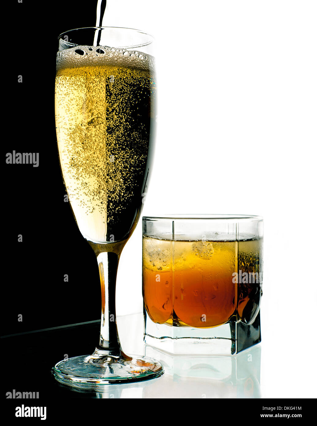 Glass of champagne and whiskey with ice. A black and white background. Stock Photo