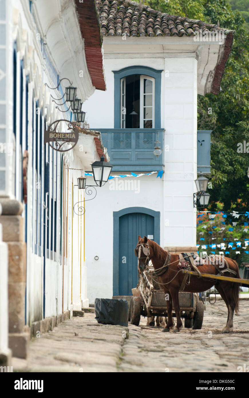 A builder's horse cart in one of the charming roads of Paraty's historic centre; Paraty, Brazil. Stock Photo