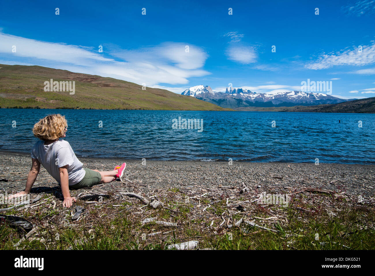 Woman enjoying a beautiful glacier lake in the Torres del Paine National Park, Patagonia, Chile, South America Stock Photo