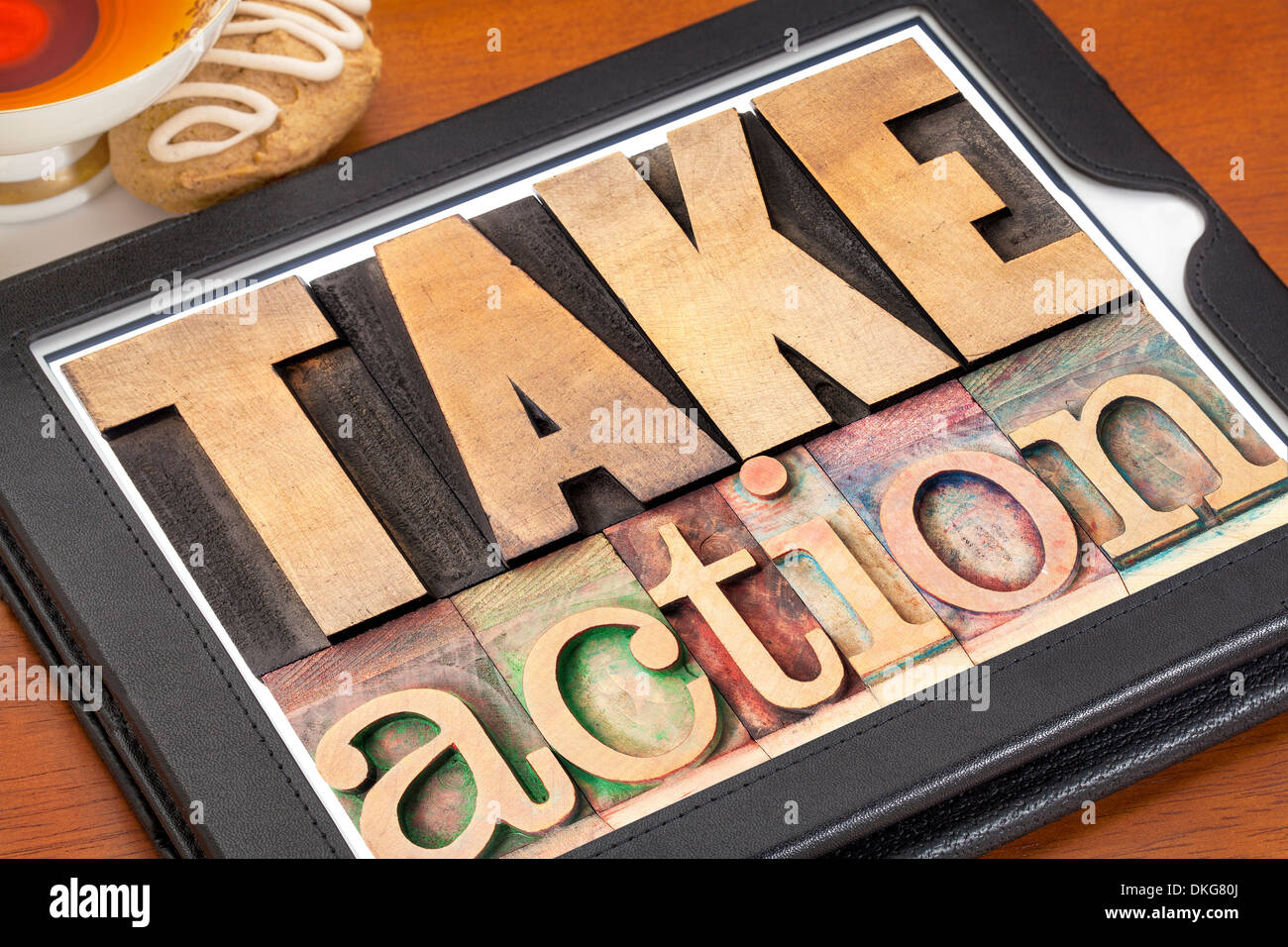 take action - motivation concept - text in vintage letterpress wood type on a digital tablet Stock Photo