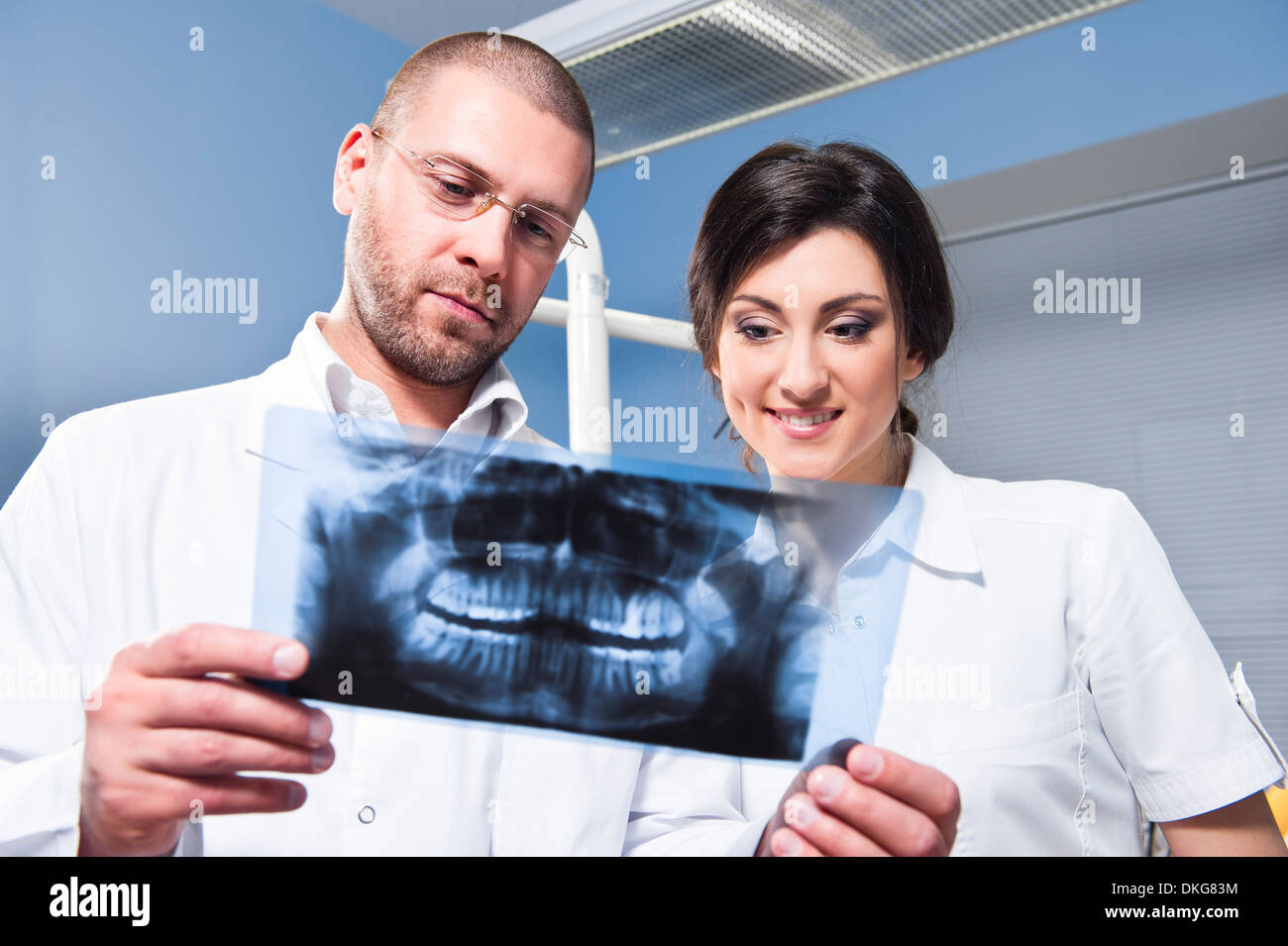Dentist and assistant checking xray Stock Photo Alamy