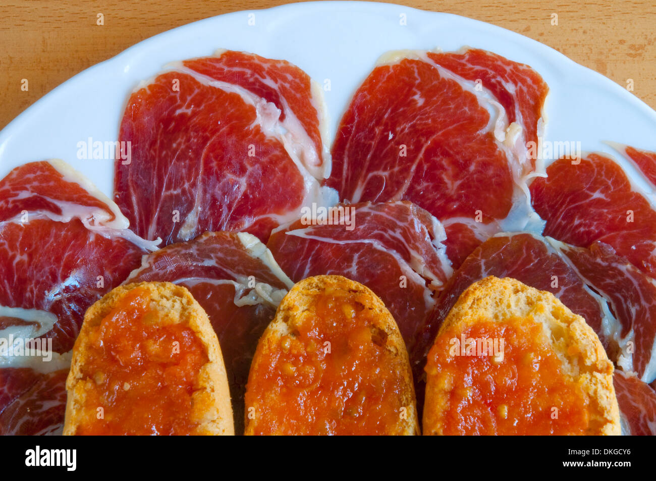 Iberian ham and bread with tomato sauce. Close view. Stock Photo
