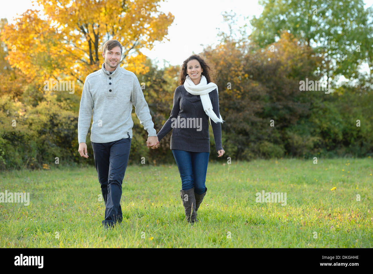 Smiling couple walking in autumn Stock Photo