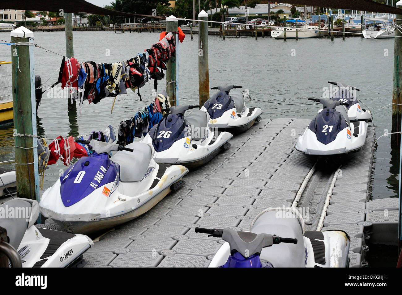 Wetsuit jet skis on landing quay hires stock photography and images