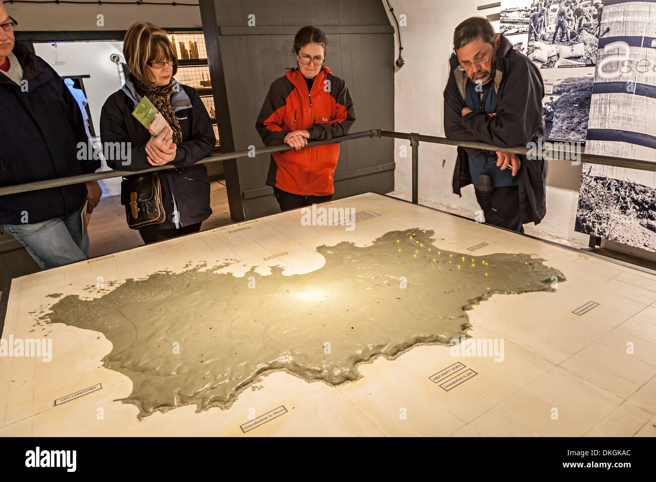 Group of tourists looking at a map of Second World War Jersey, German War Tunnels, Jersey, Channel Islands, UK Stock Photo