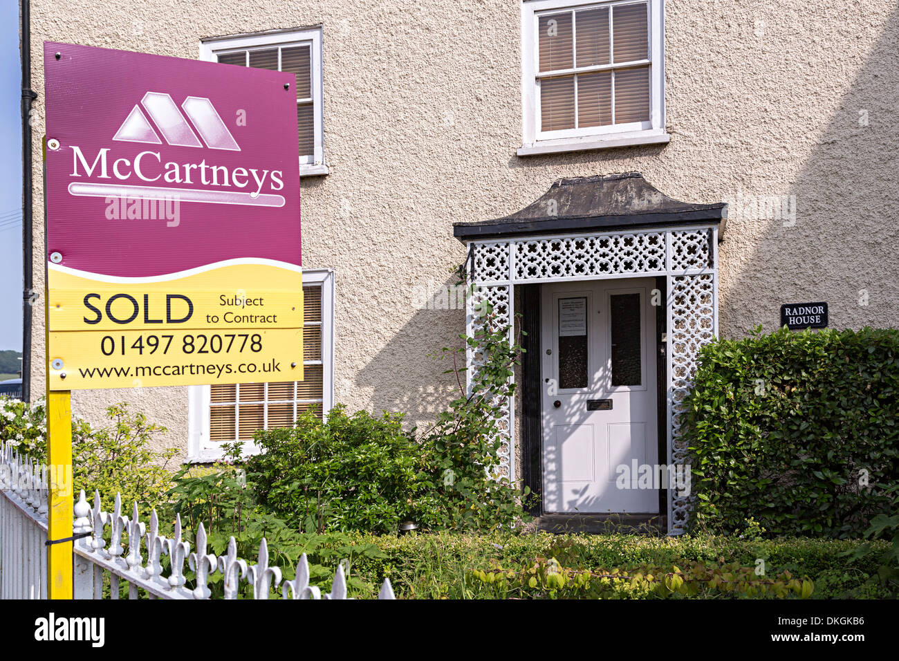 Sold sign on estate agent notice outside house, Hay on Wye, UK Stock Photo