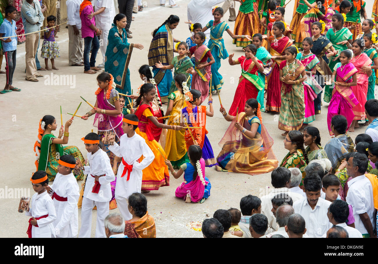 Indian girls in traditional dress dancing at a festival in the streets ...