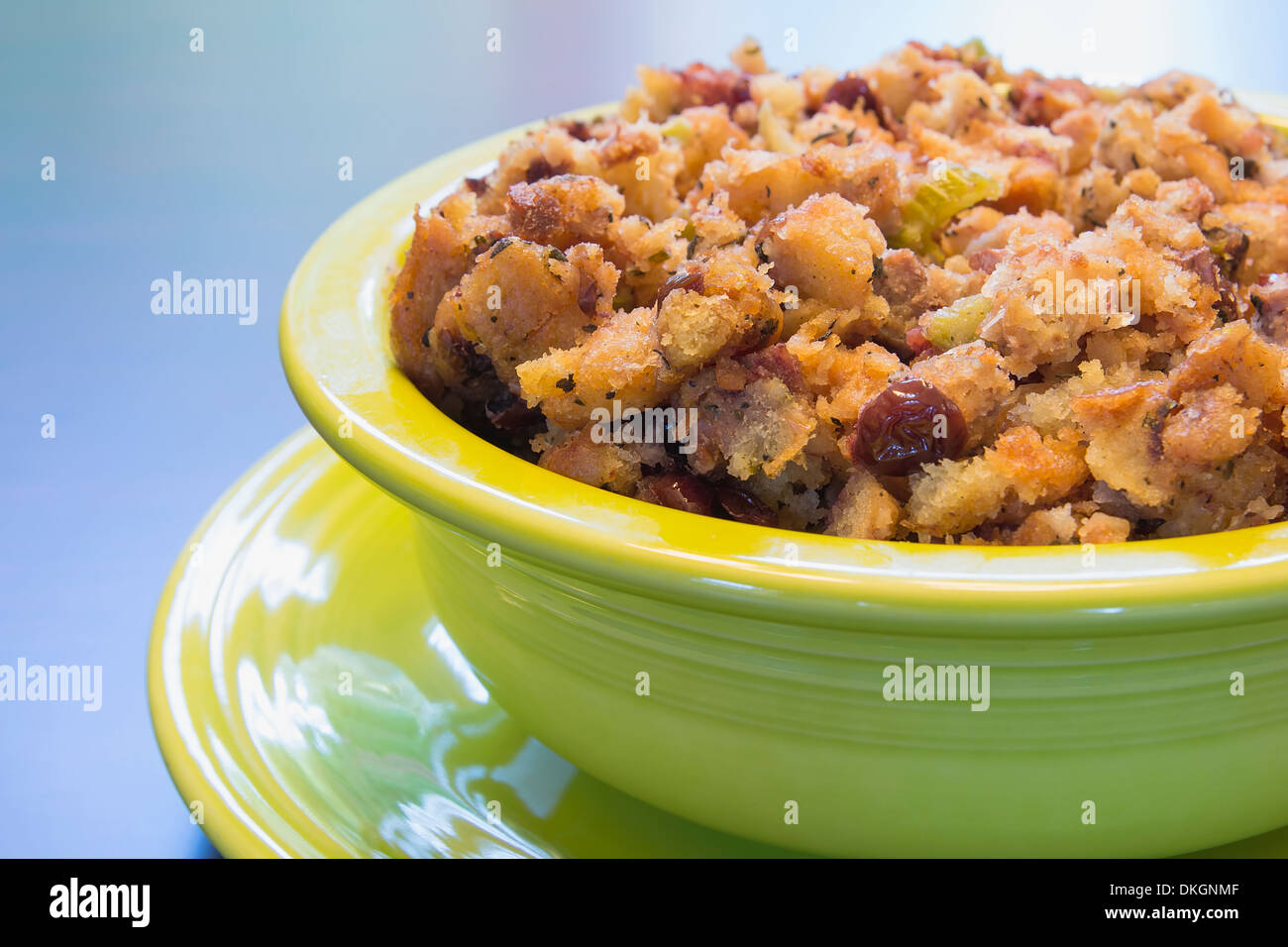 Thanksgiving Day Turkey Stuffing with Corn Bread Celery Cranberry in Green Bowl on Wood Table Closeup Stock Photo